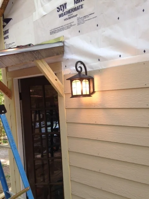 I had already run wiring for an outdoor light, so it was just a matter of making some connections and hanging this one that Shannon picked out. I like it.