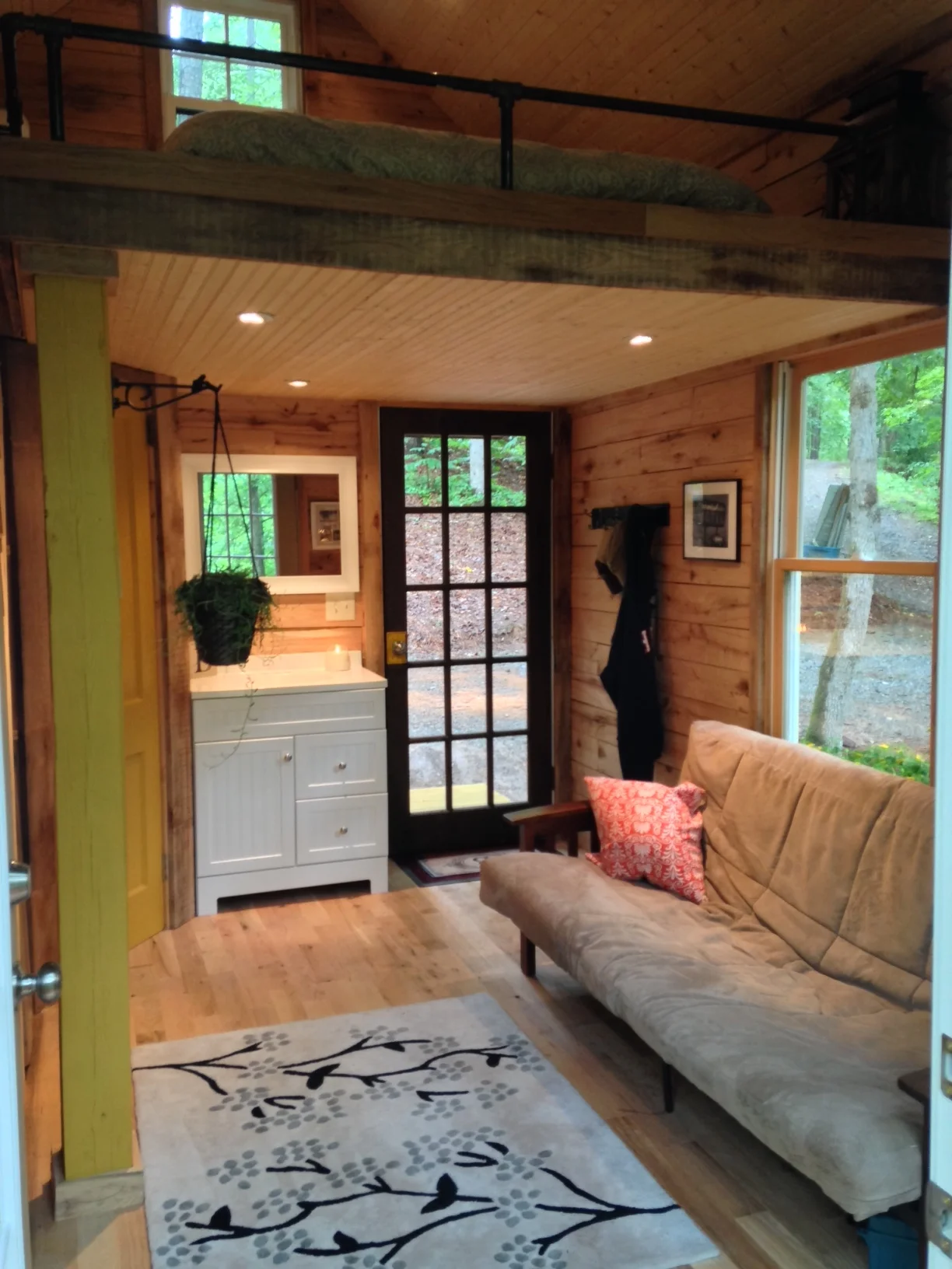 I'm 6'2", and I have roughly five inches to spare under the loft. The walls are 9 feet, giving us an extra foot of headroom over a traditional loft. I love the extra room!