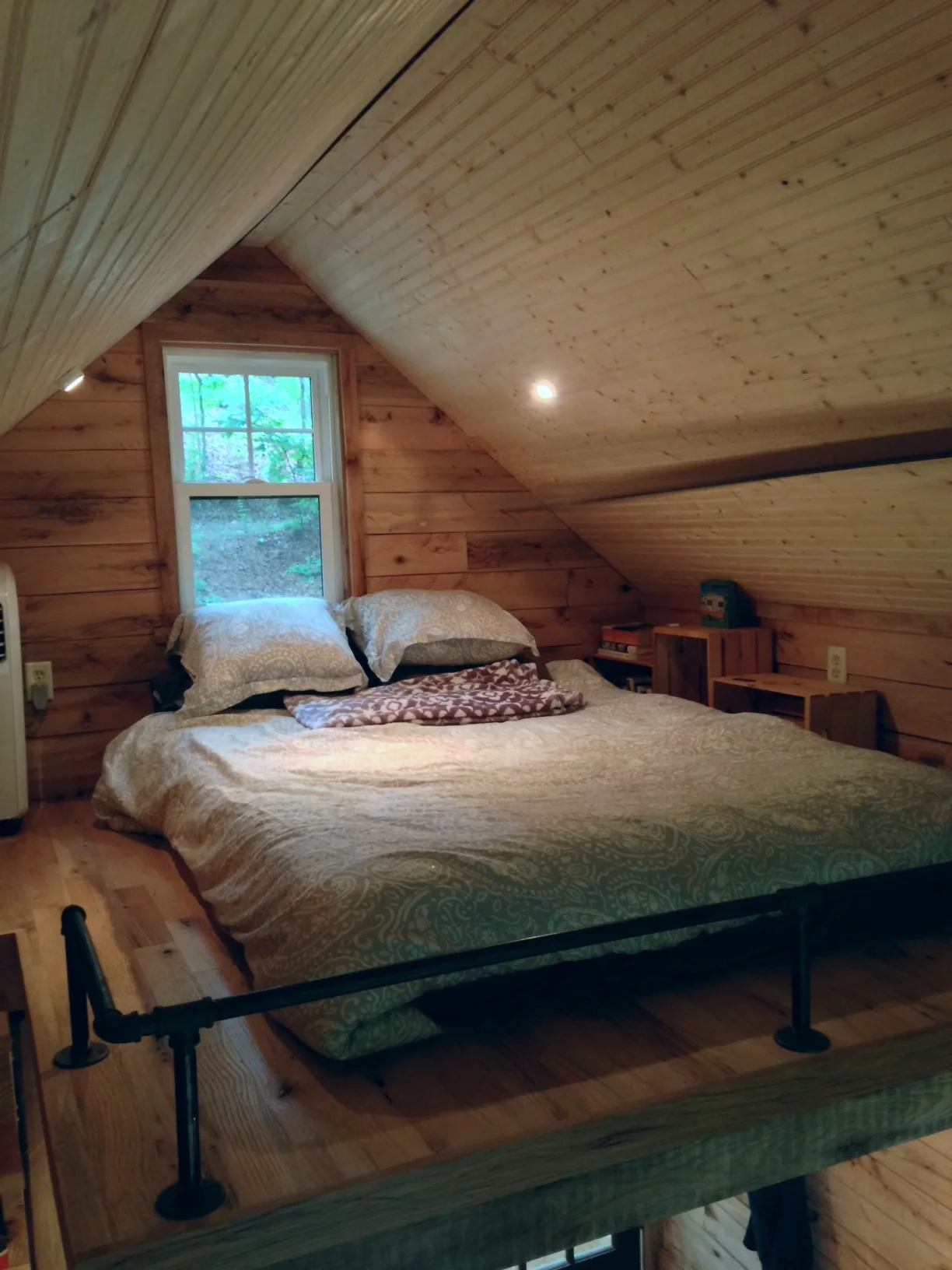 We used 1" plumbing pipe to serve as a guardrail and handrails in the loft. Just to the left, you can see the LG A/C unit. I'm fairly tall, but don't feel cramped in this loft. That's a queen sized mattress.