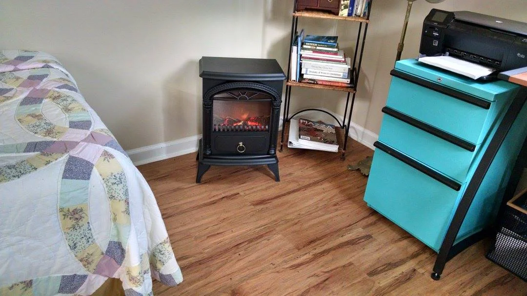 I'm a big fan of electric faux stove heaters. They add a little ambiance, and do a fine job of heating small spaces.