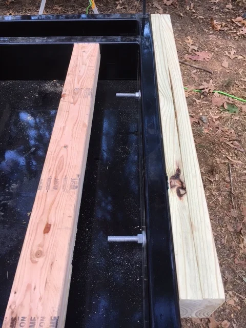 I gained a few inches on the back of the trailer by attaching 2x6s to the frame of the trailer with 1/2" lag bolts. 