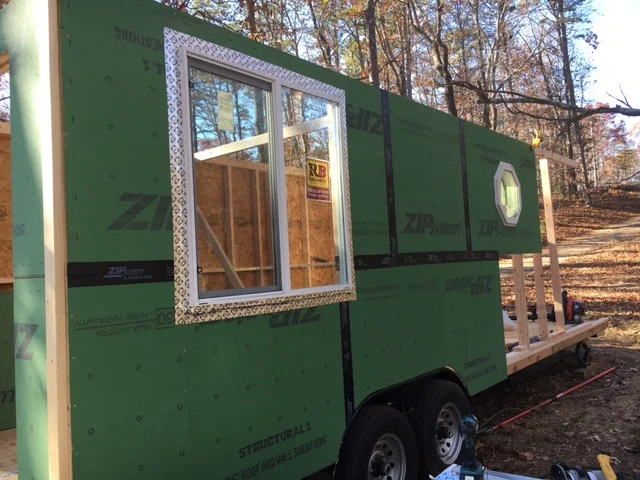 The large window is centered in the living room. The octagonal window will be in the bathroom. The kitchen will be in between....Hey, it's TINY living!