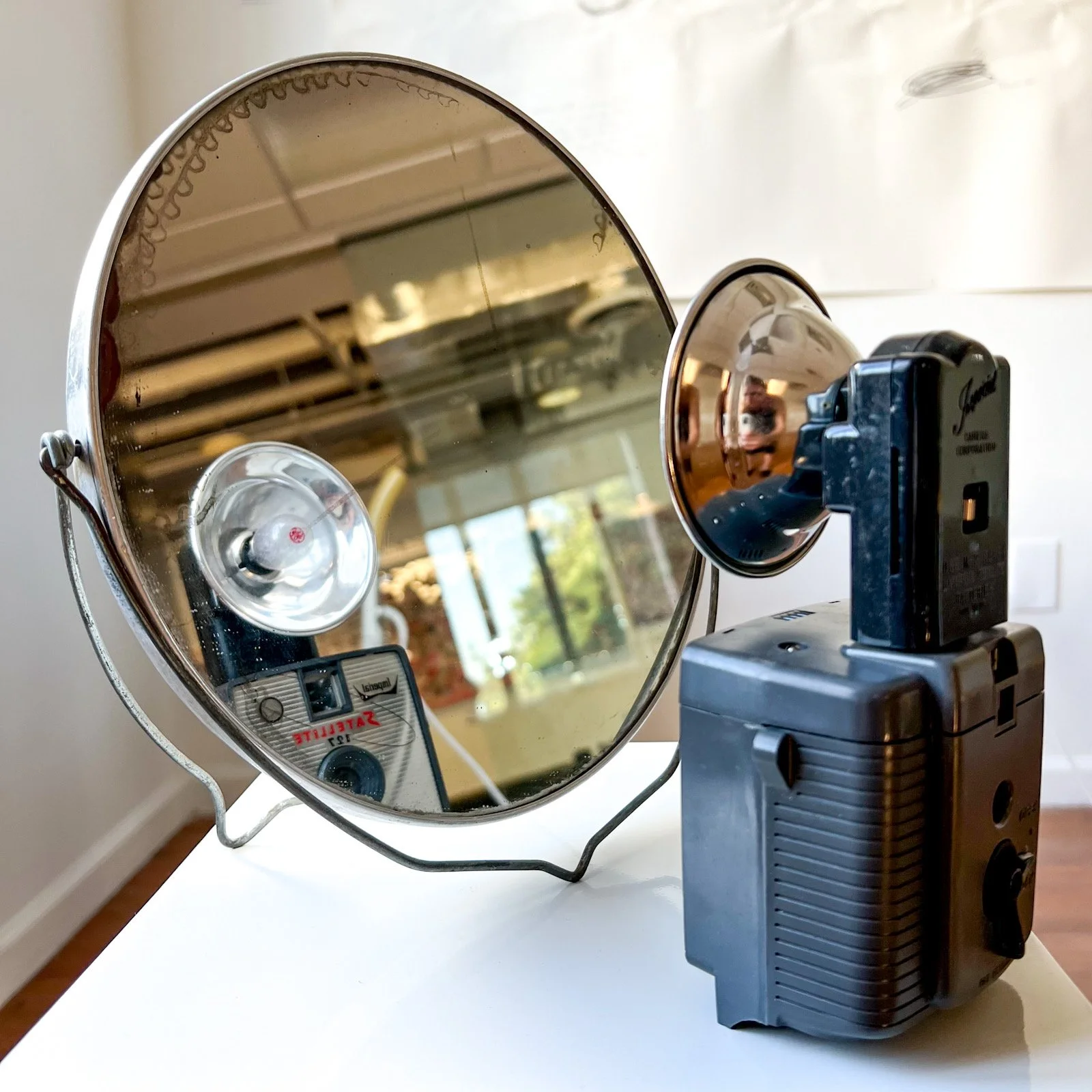  'Blindside', Camera with large flash, round tabletop mirror with metal frame, 2024 