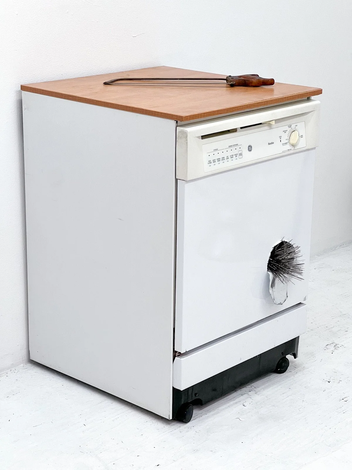  'Outburst', 28.5 x 23.5 x 36, 2024, Dishwasher, metal spikes, saw 