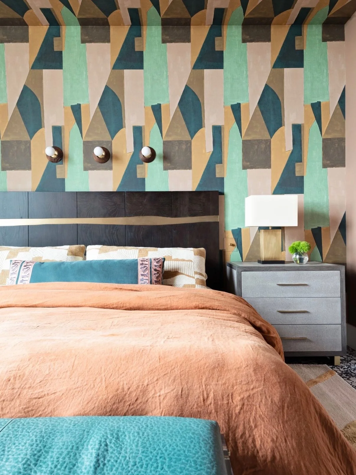 For this primary bedroom in a high-rise apartment, the goal was to create a warm and restful space that still felt energetic. 🛏️ 

We used dramatic yet welcoming brown tones on the walls, paired with shades of teal, golden hues, and pops of blush. T