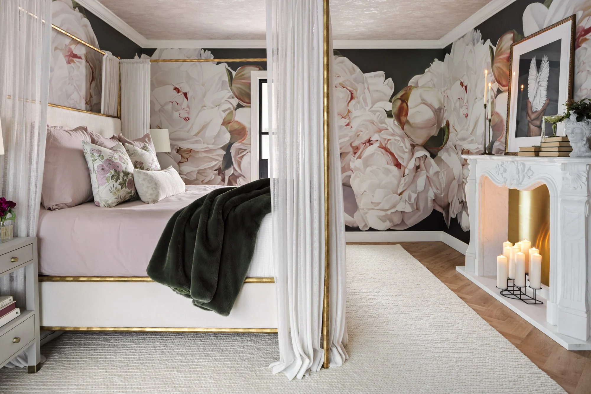Bedroom with oversized floral mural wallpaper, canopy bed and fireplace