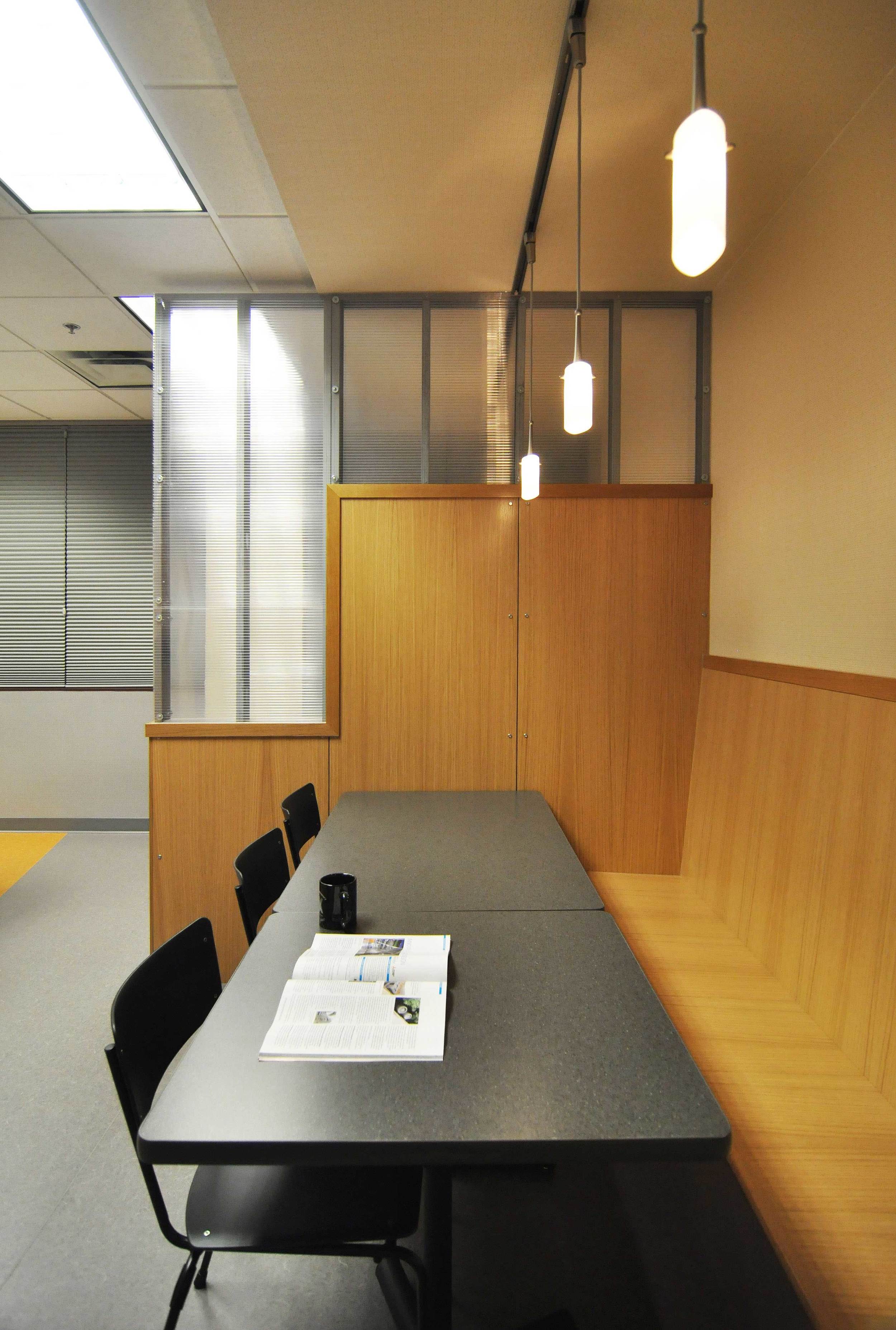 White oak and polycarbonate panels combine to provide both privacy between seating groups and filtered transparency