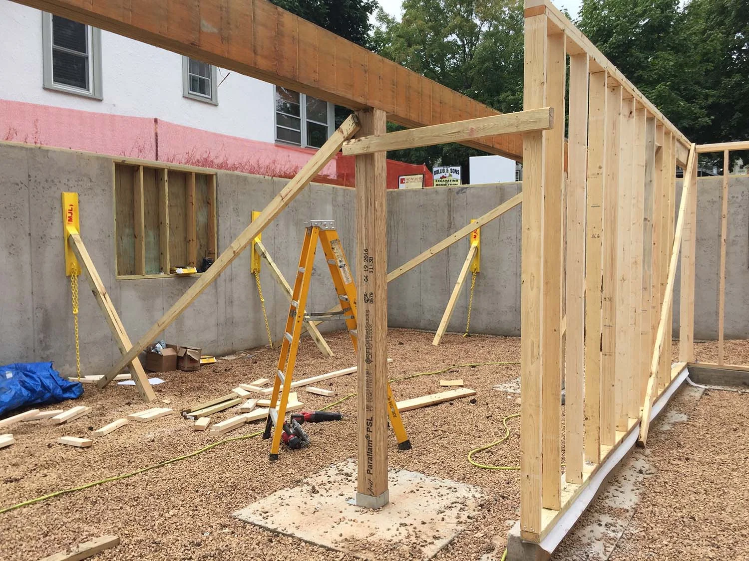 Photo taken Friday, 1:20 p.m., looking southwest from a future office to a future bedroom (the framed-in wall opening can be a double window opening into an area well). The stair up will rise between the column and stud wall.