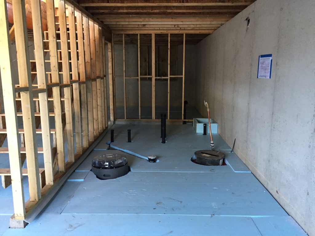 The 2015 International Residential Code requires R-10 insulation below slabs in our climate zone. We're going for 150% of insulation requirements in all envelope assemblies. A PassiveHouse, in contrast, would probably have R-40 or greater below the floor slab.