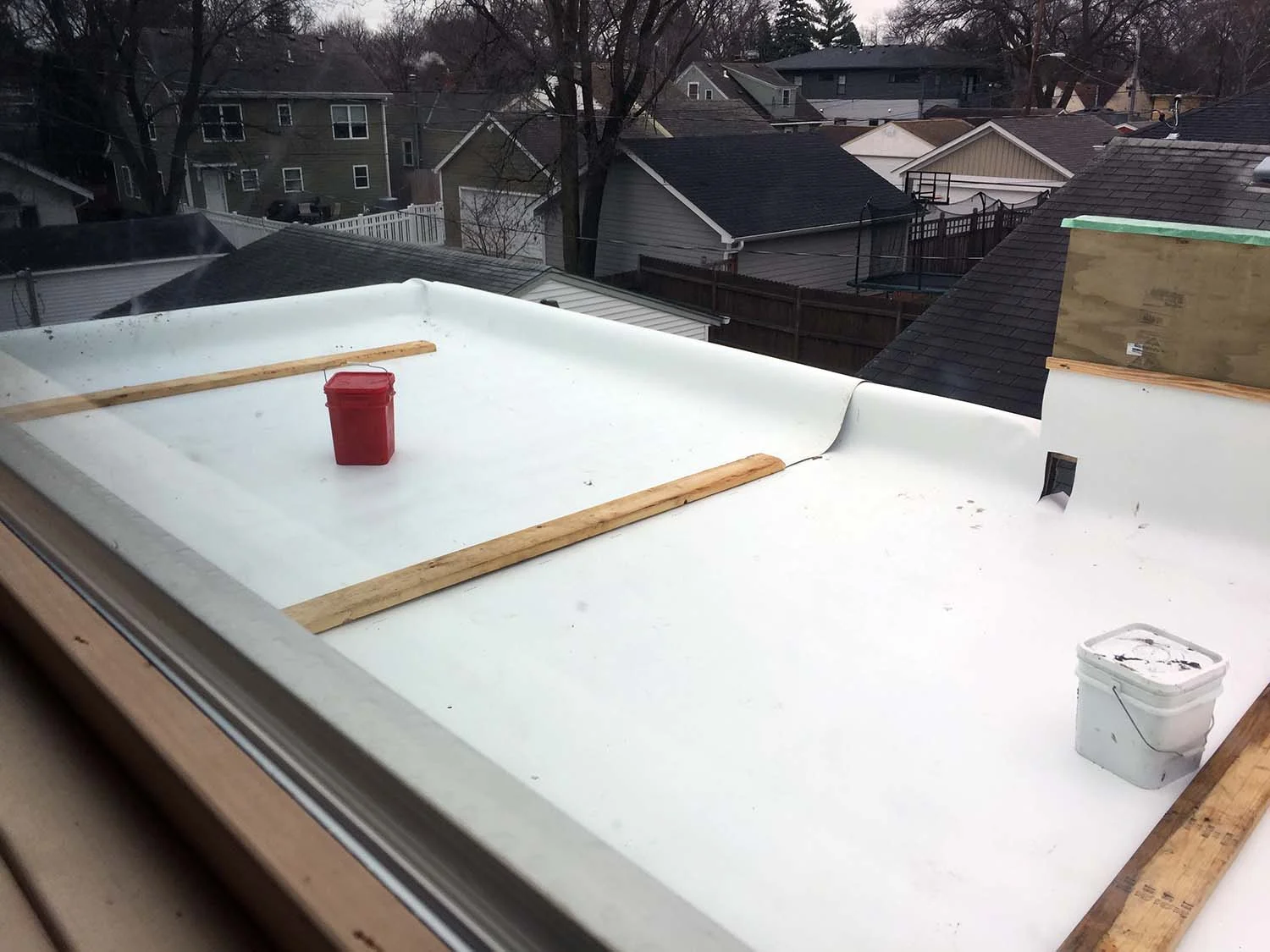 Sheets of Thermoplastic Polyolefin membrane, pre-seam welding, cap flashing and termination bars. The white color, where not covered, will aid in minimizing heating up the immediate environment and support the idea of "cool roofs".