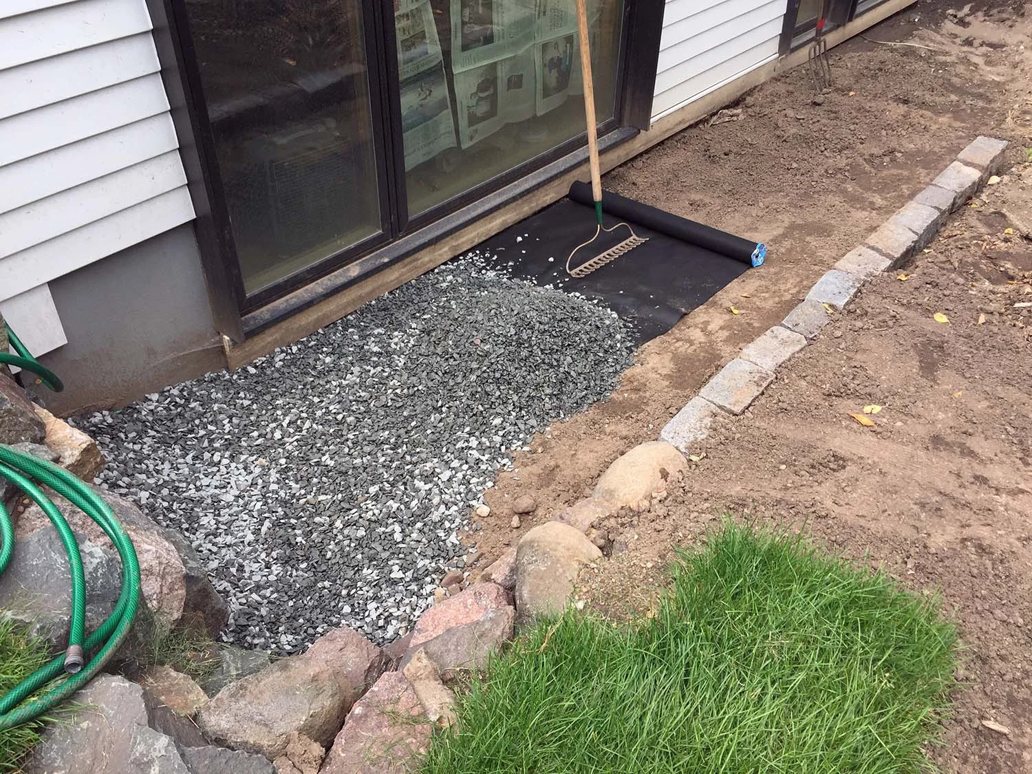The stone is from Landscape & Concrete Center in Minneapolis: ¾" Dresser Trap, laid over filter fabric.