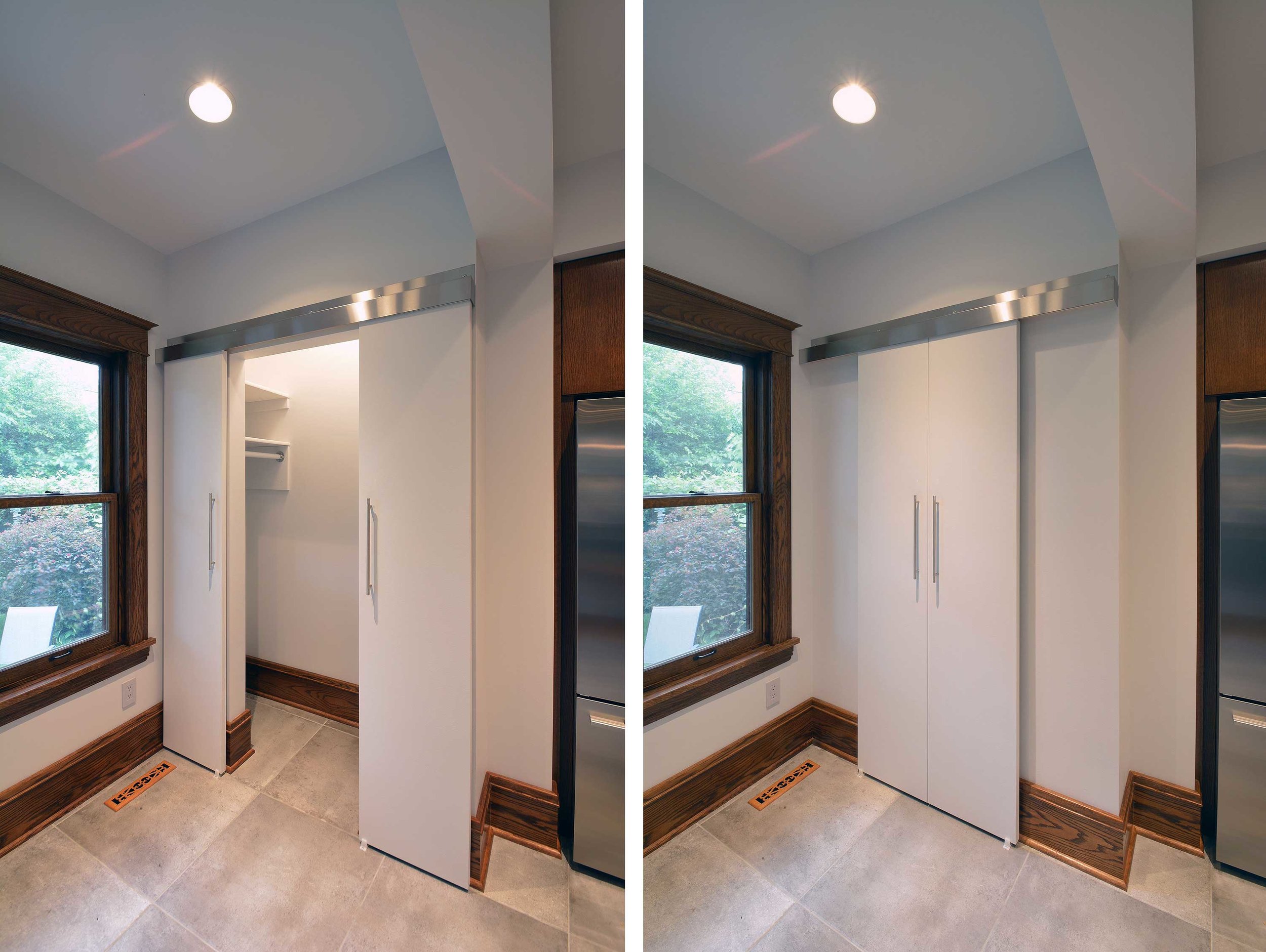 Custom bi-parting barn doors conceal a closet