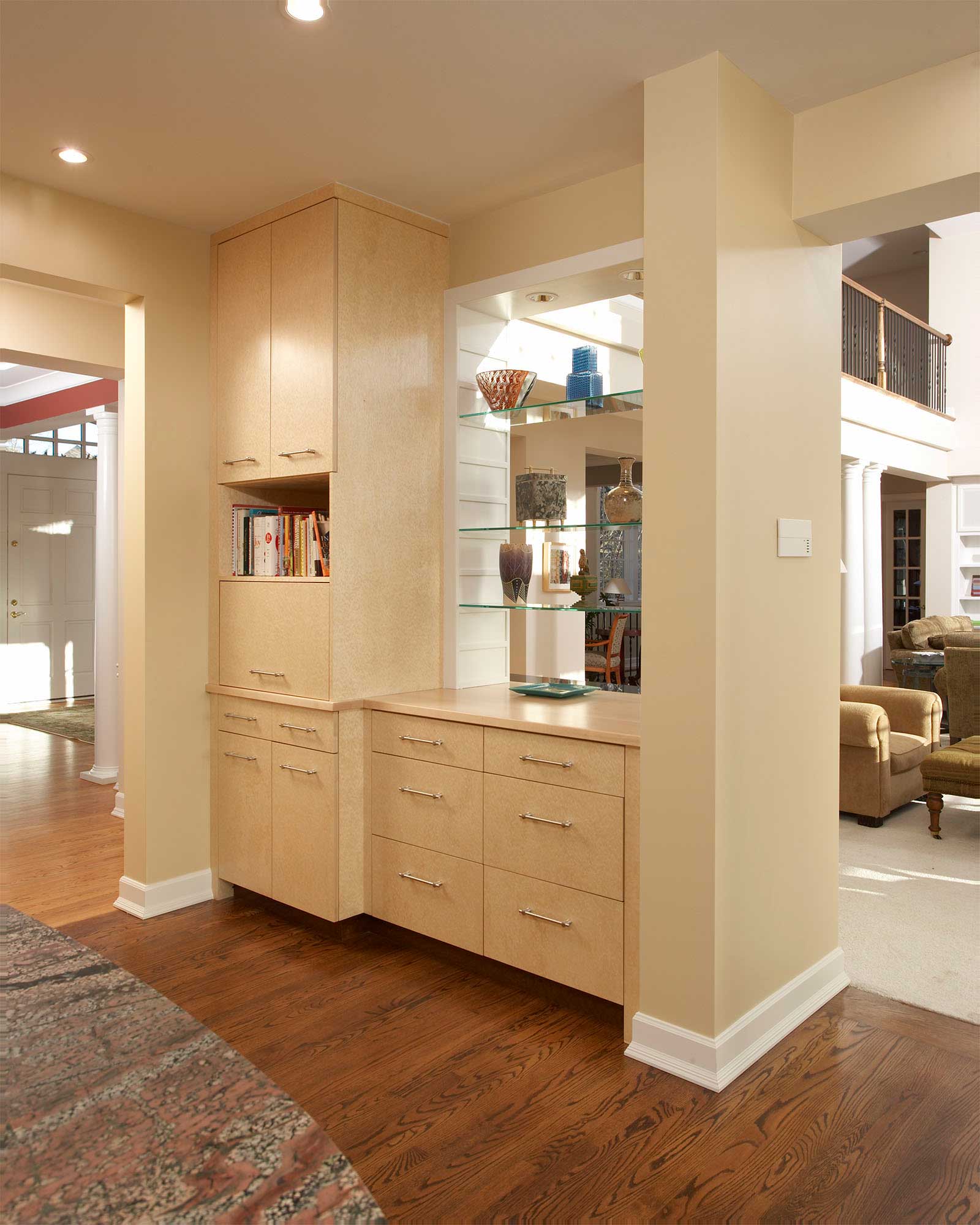 Partially open cabinetry separating the kitchen and living areas.