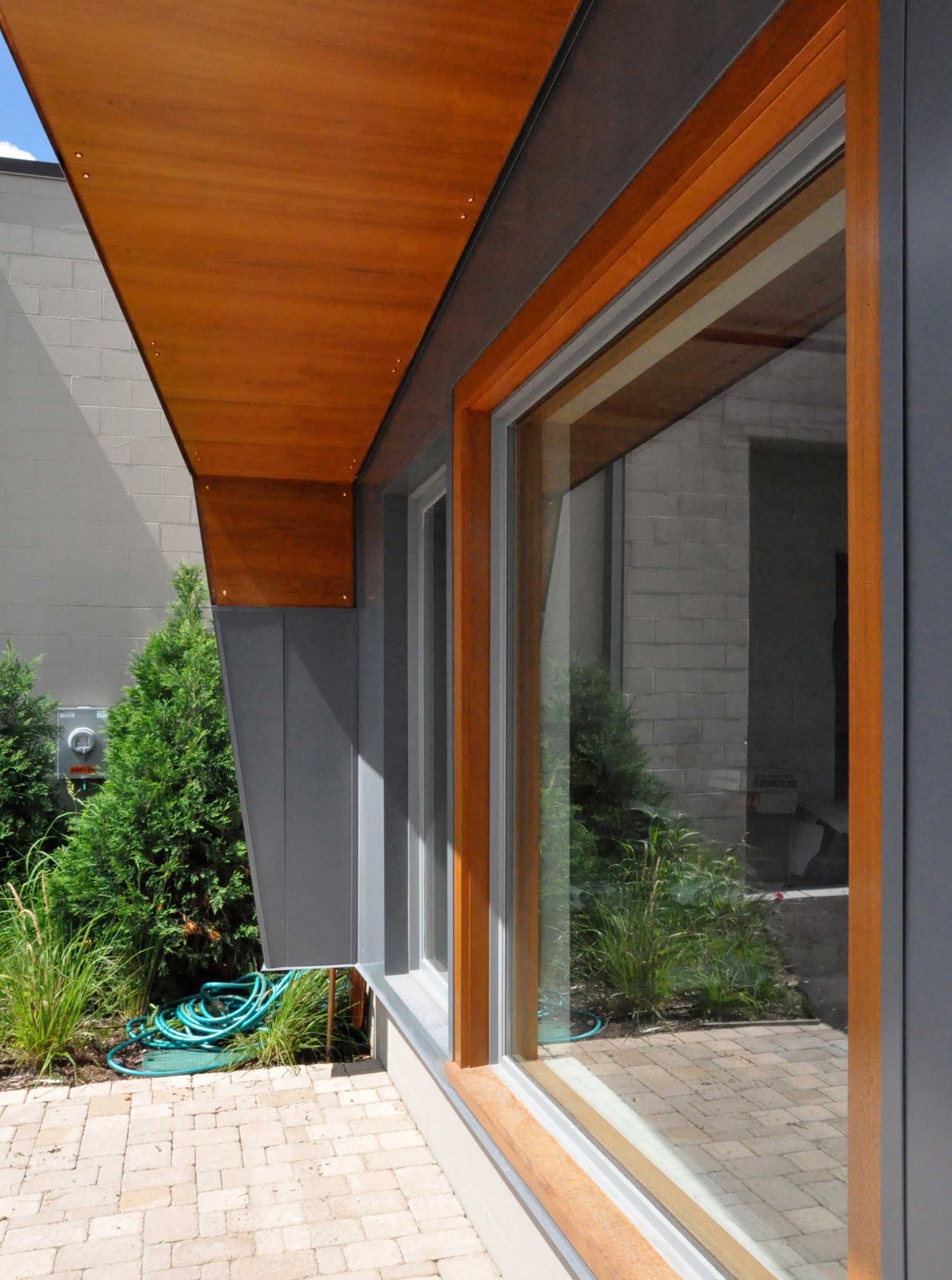 This custom steel-and-cook canopy shelters the entry to a cabinetry shop in Minneapolis.