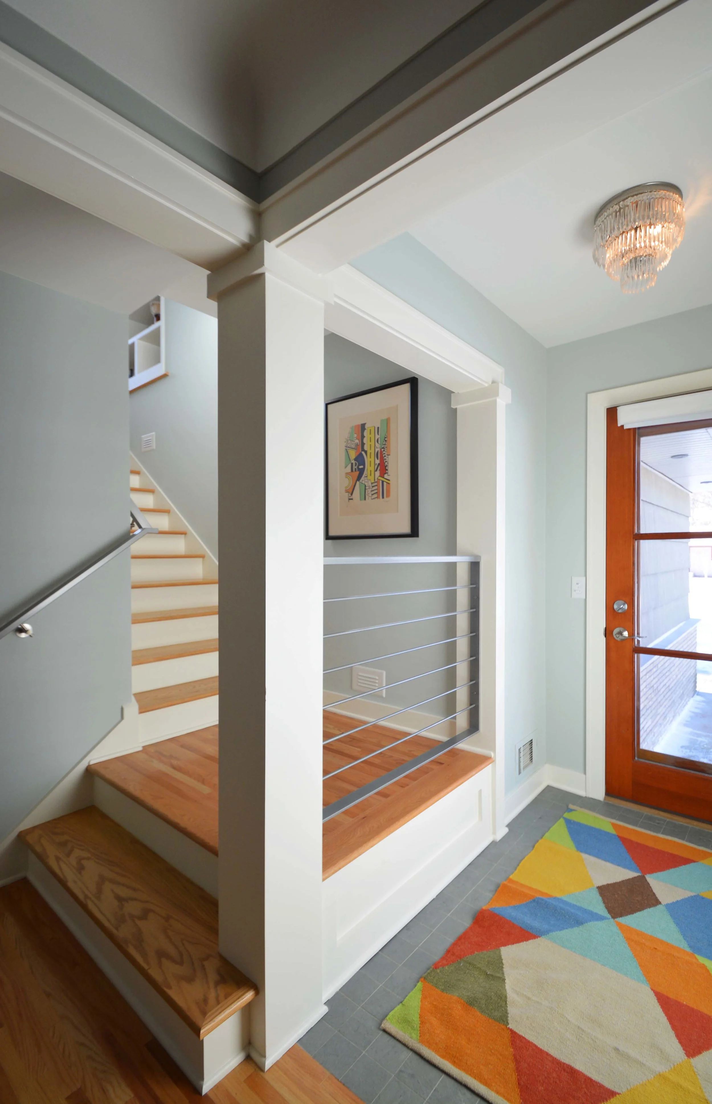  The new entry features an open stair landing and crisp railings by Primitive Precision.  Interiors consultant: Kevin Mangan. 