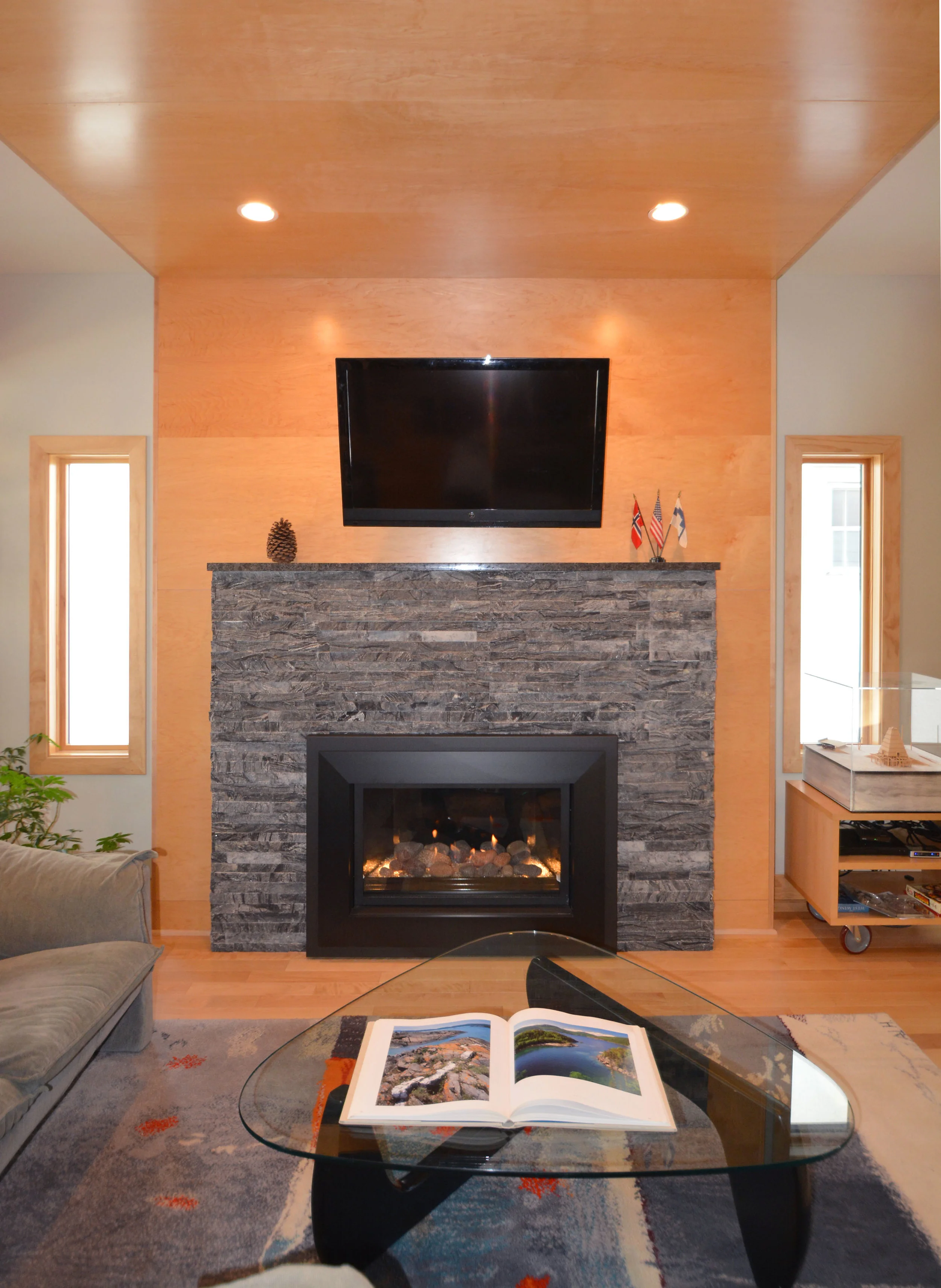  Living room fireplace with natural stone surround. 