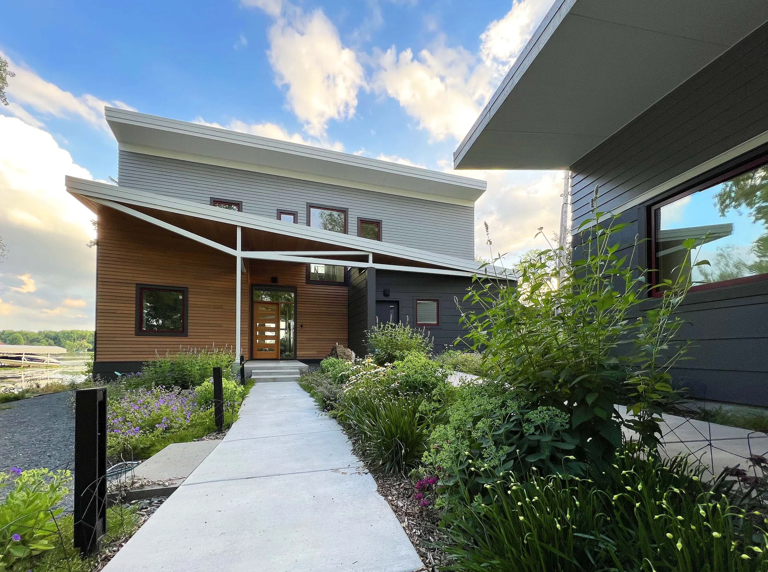  Entry view, with the detached garage to the right.  The garage features a wood shop with a view to the lagoon. 