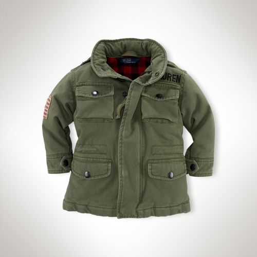 This Ralph Lauren Cotton Flag Field Jacket is a ruggedly handsome Army Jacket with plaid lining, a distressed flag patch at the arm, embroidery above the left pocket, epaulets, and a stowaway hood. 