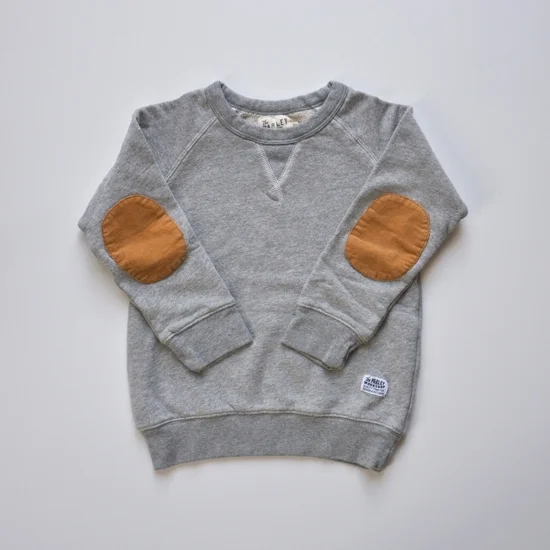 From Yarnmade, this Parley Workshop All-Day Sweatshirt is the perfect every-day sweatshirt. It is made from soft premium french terry with corduroy elbow patches and a small handmade label on front. This is truly a lux Grey Heather Sweatshirt for your Little One!