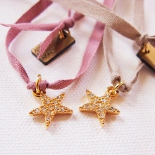 This ATELiER ATSUYO ET AKiKO Star Dia Ribbon Necklace is a beautiful sparkly brass star charm on a rose or beige cotton cord. It will make your Little Ice Princess feel as though she just won gold when she wears it! I love it so much, I am thinking of purchasing it, as I think it would make a cute bracelet with the ribbon wrapped around your wrist! 