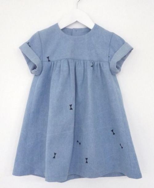 This Oh My Kids babydoll denim dress is an adorable heavyweight denim dress with a washed look and a hand-printed bows all-over print (bow prints are also trending in children's wear this spring).