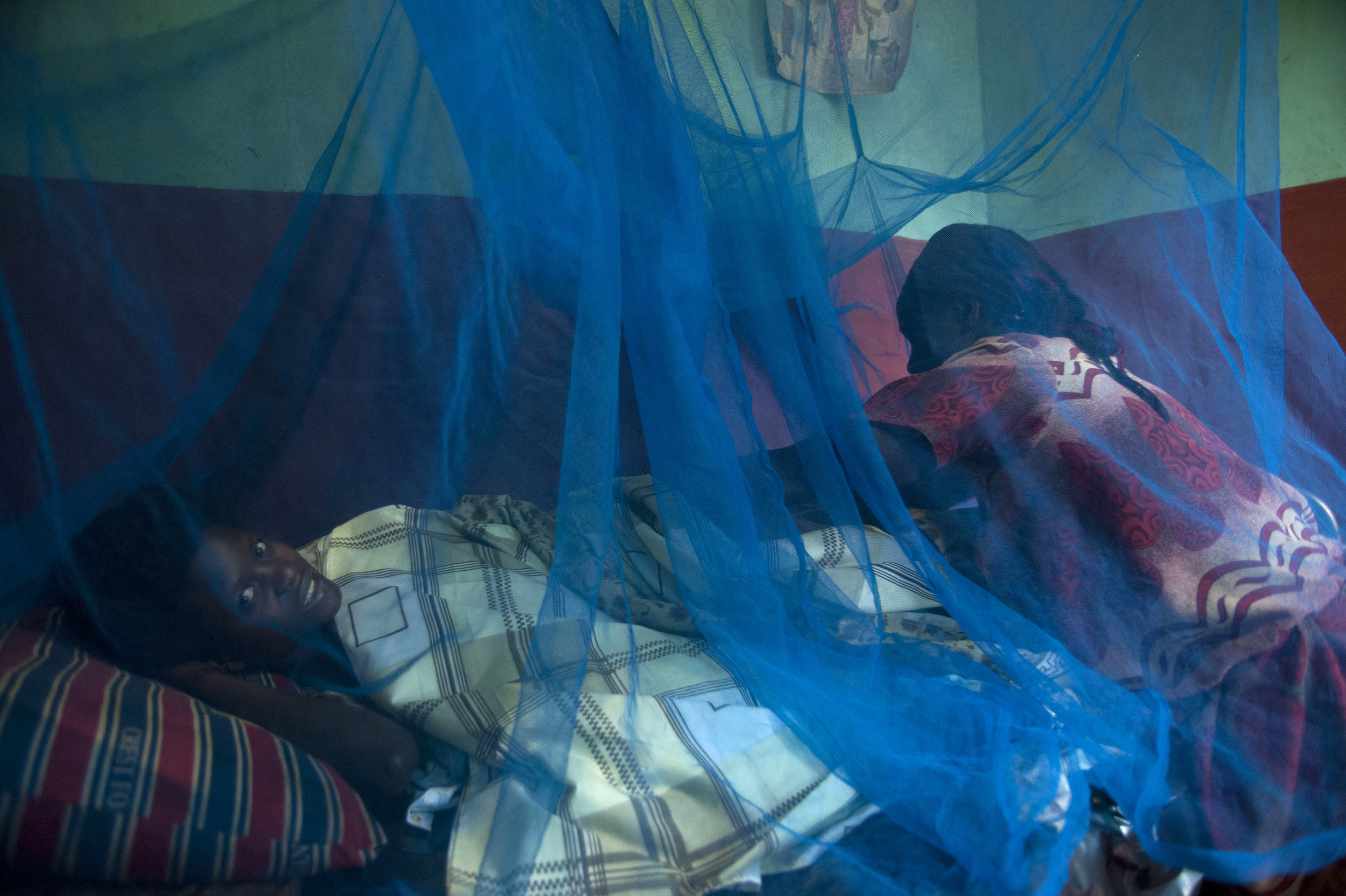  A nurse tends to a women who has just given birth, Bujagali , Uganda.  