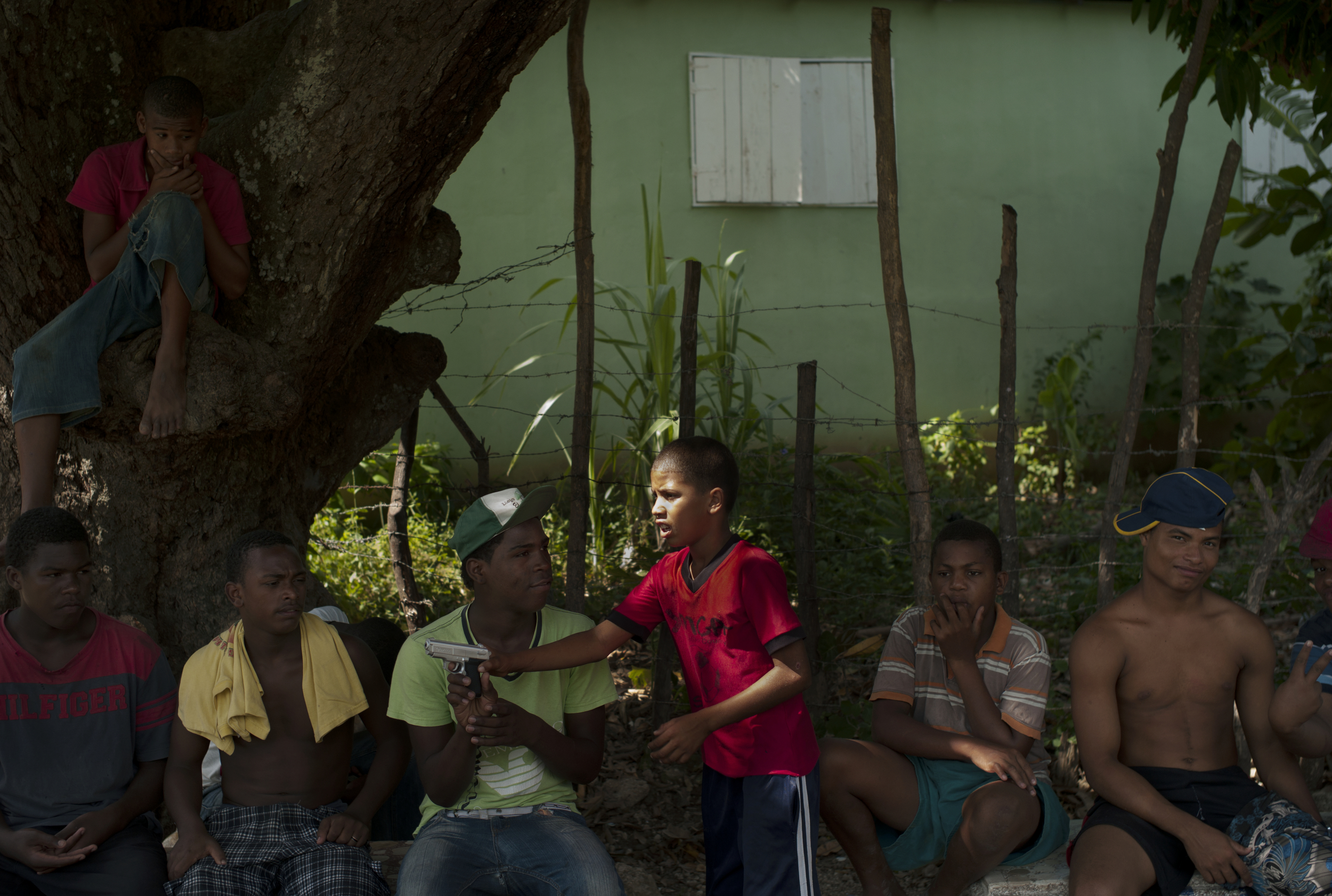  Kids play with a toy gun,&nbsp; Paraiso, Dominican Republic.  