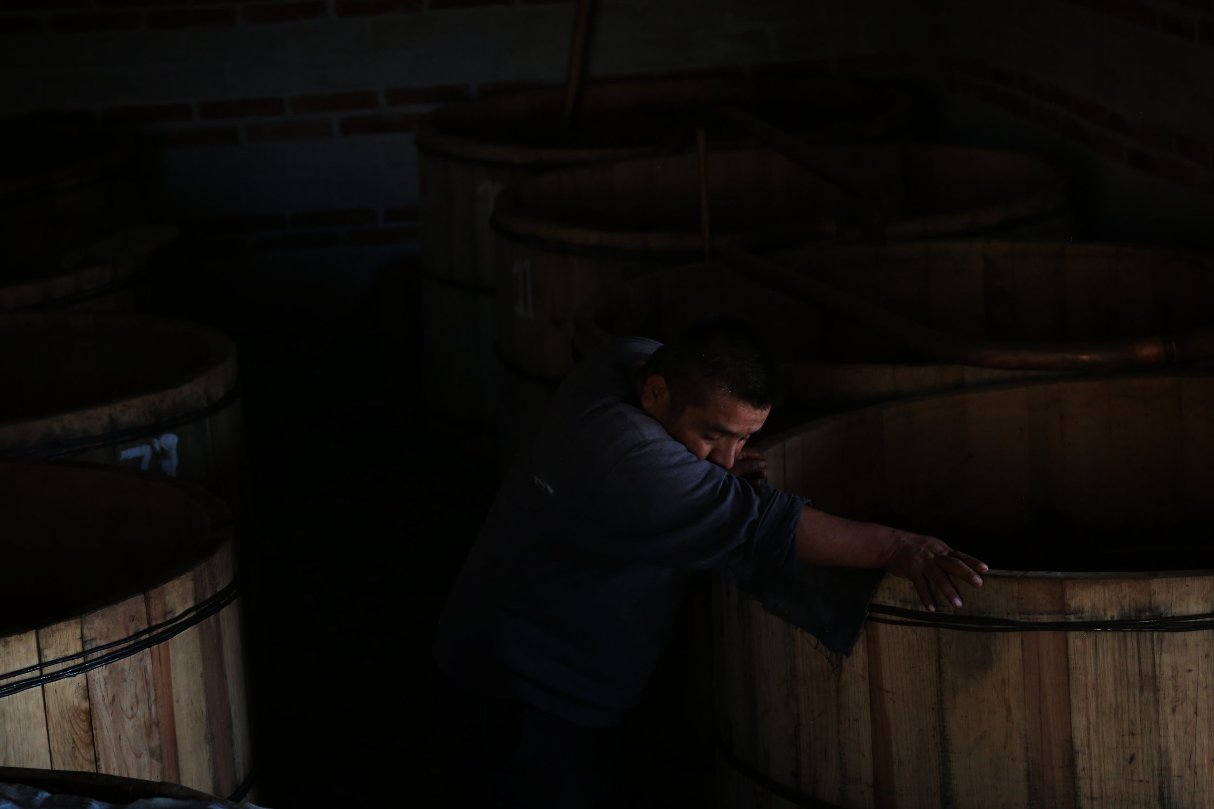  Fortunato Angeles rests on a fermentation tank at his palenque in &nbsp;San Juan del Rio, Oaxaca.  