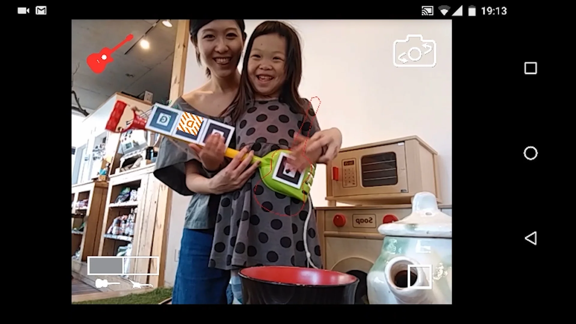 Screen of the Android phone. Graphics appear on top of the post-it notes held by a girl.