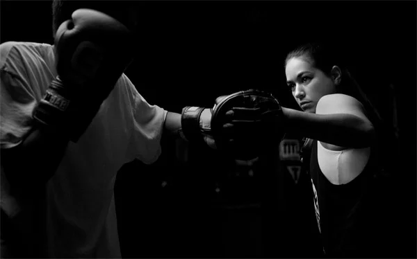 Rachel Schley, owner and head trainer, working out with "B" Gonzalez.
