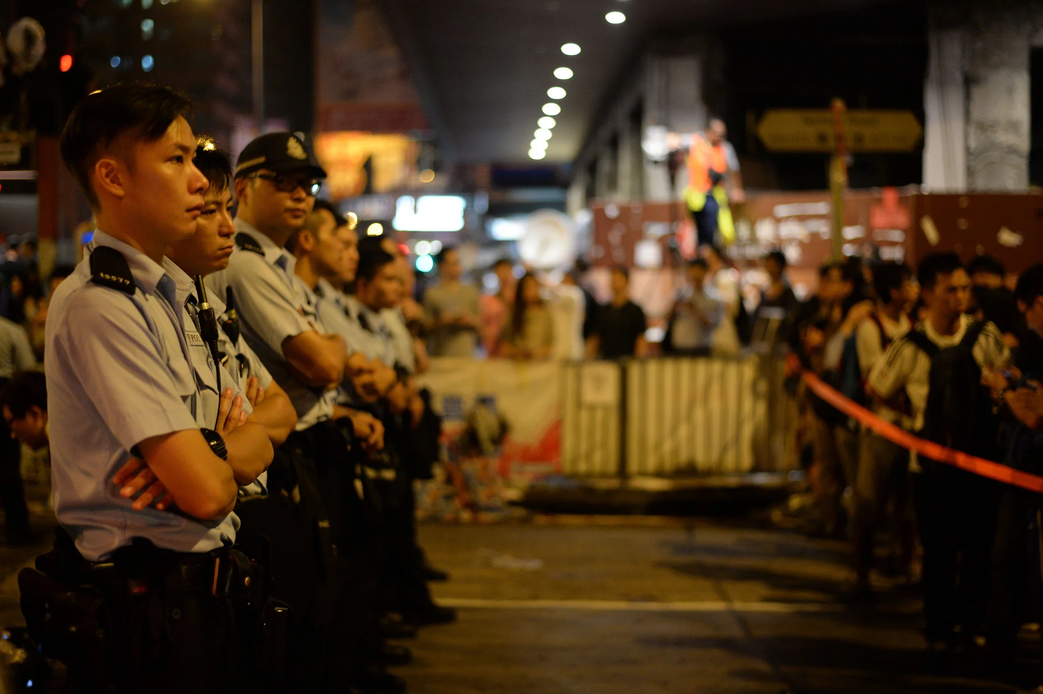 Protestors yell at and ridicule police officers in Mong Kok, demanding explanations after a night during which anti-occupy agitators assaulted secondary students, women and journalists.