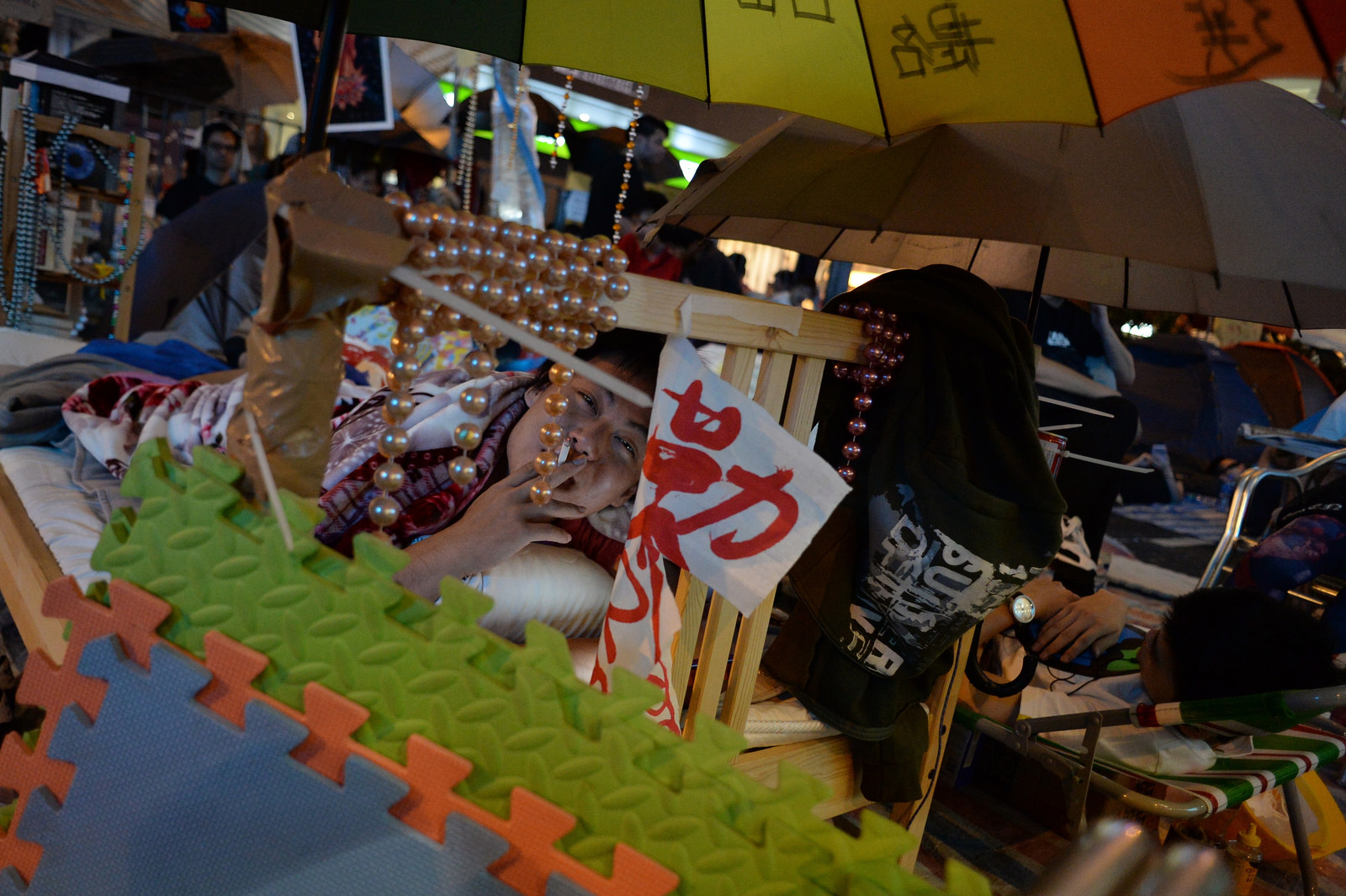 An occupier relaxes on his bed in Mong Kok.