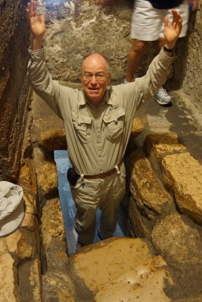 Picture of Mike Mason emerging from Lazarus's tomb, which is in the ground.
