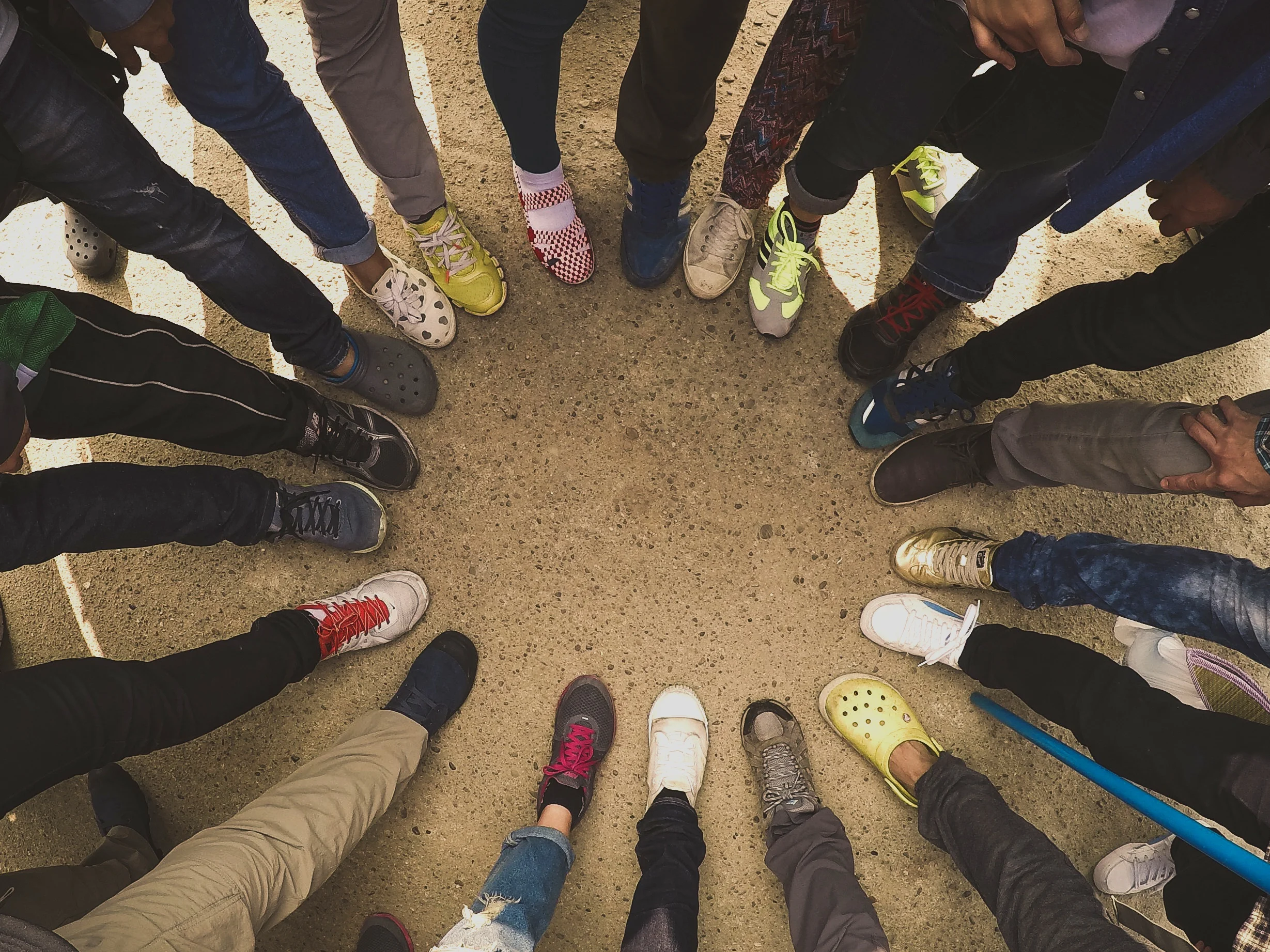 Canva+-+Top+View+of+Feet+of+People+Standing+in+a+Circle.+Runners+Standin.jpg