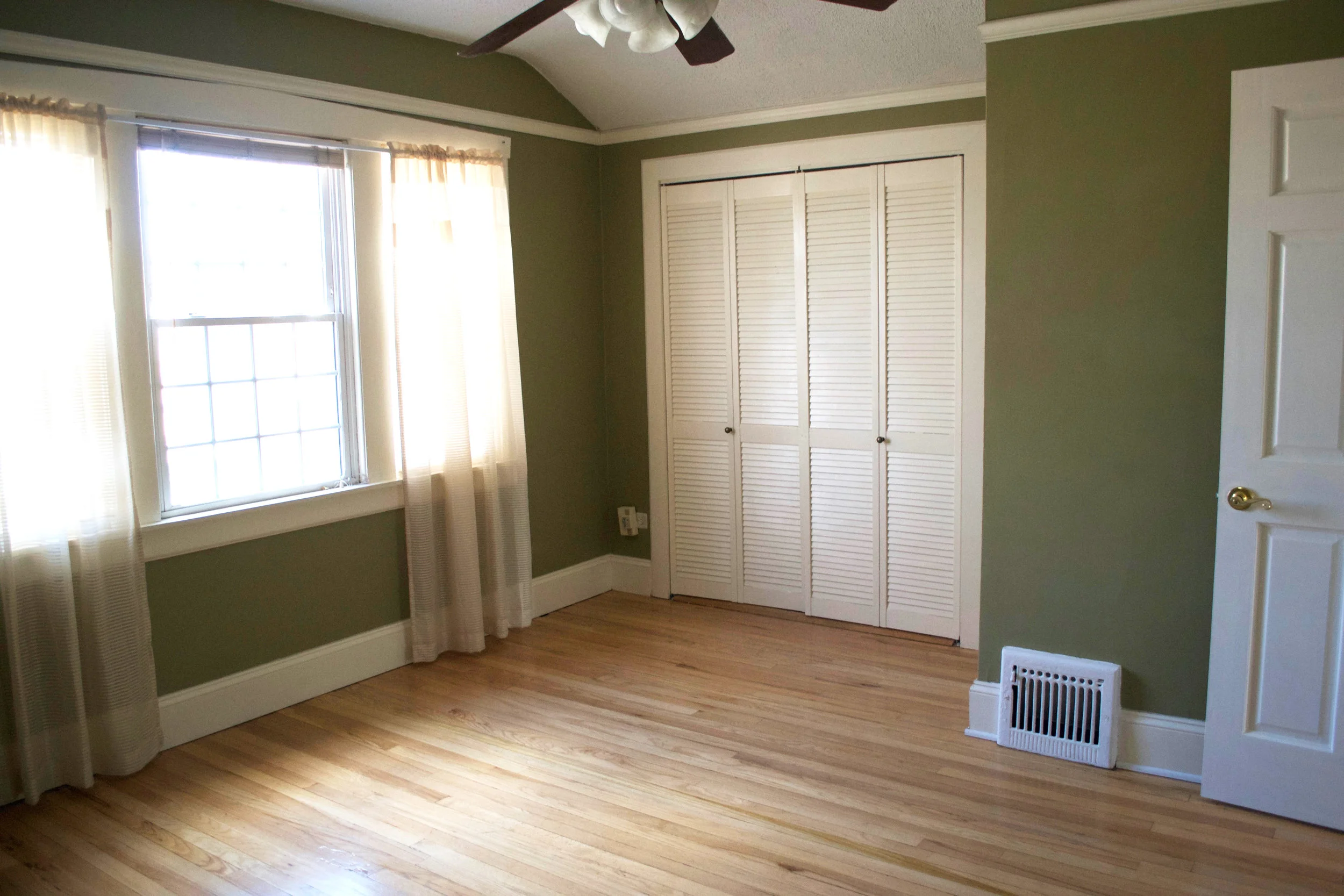 We removed the popcorn ceiling and the awkward trim, as well as painted the walls and replaced the doorknob, ceiling fan, and window coverings