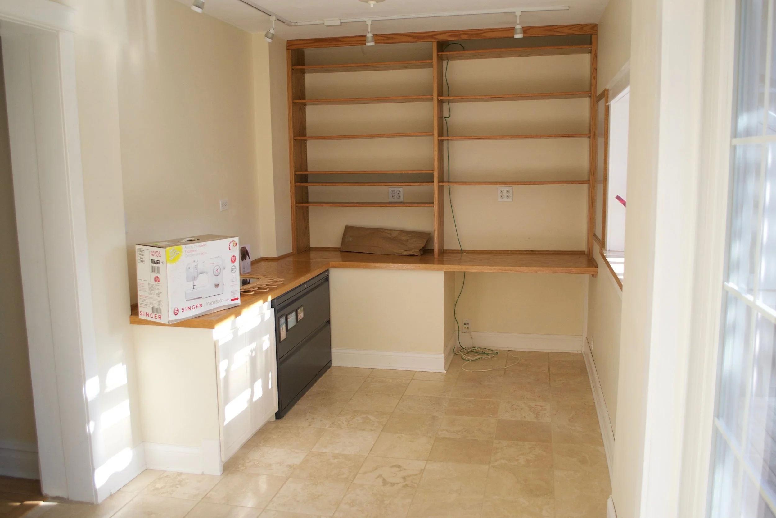 The built-in desk and shelves of our back room office
