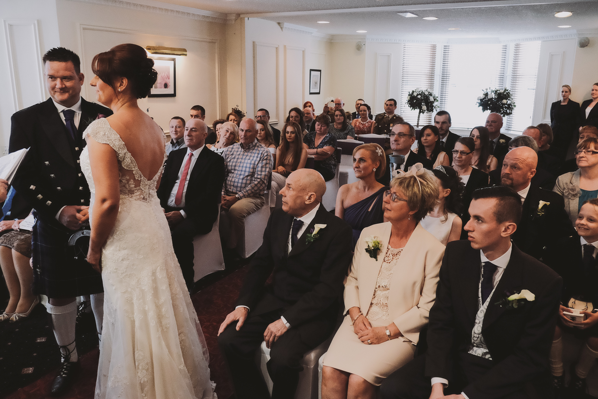 Newcastle Wedding Photographer // Bride and Groom during wedding ceremony with family watching