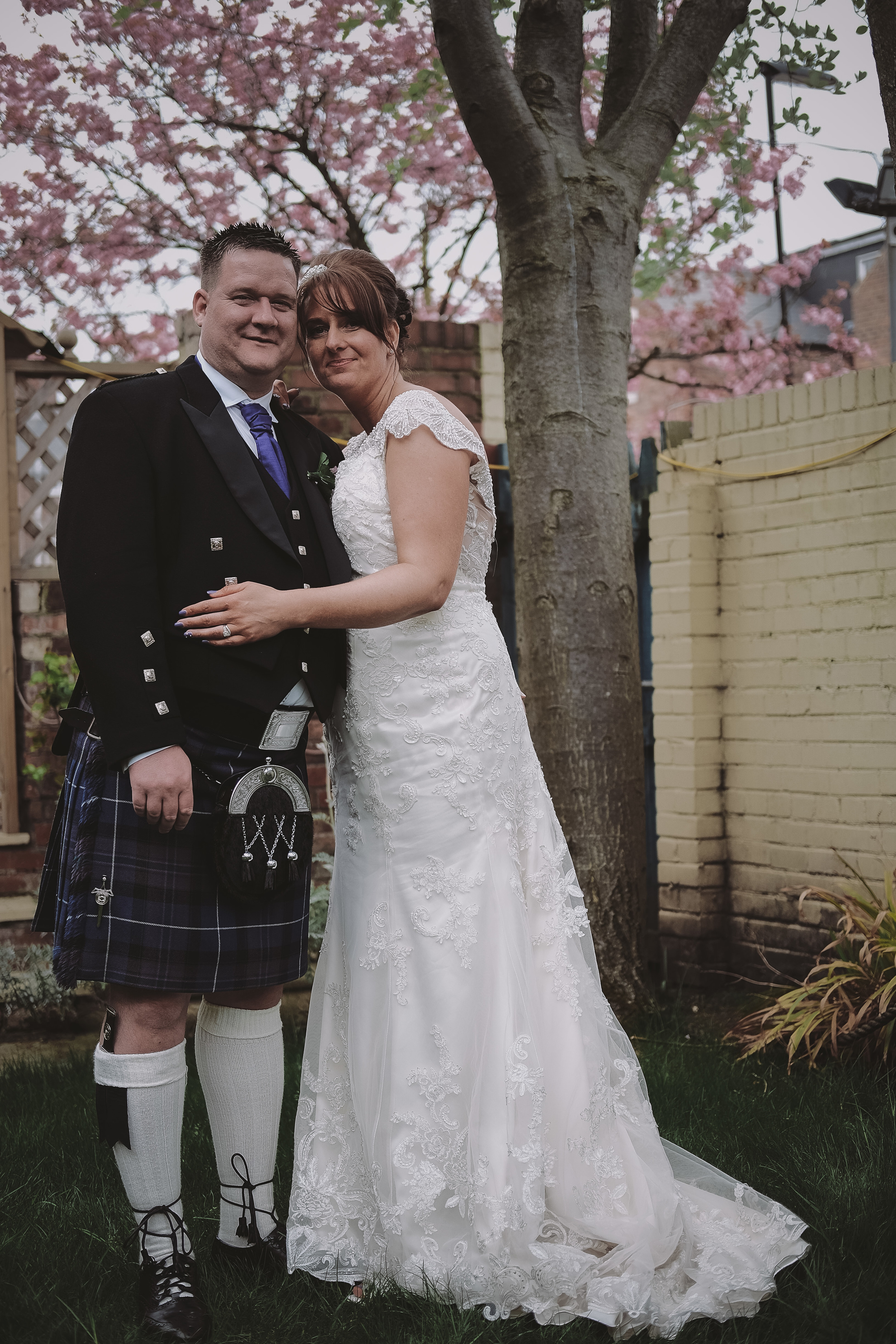 Newcastle Wedding Photographer // Bride and groom pose under blossom tree at Caledonian Hotel