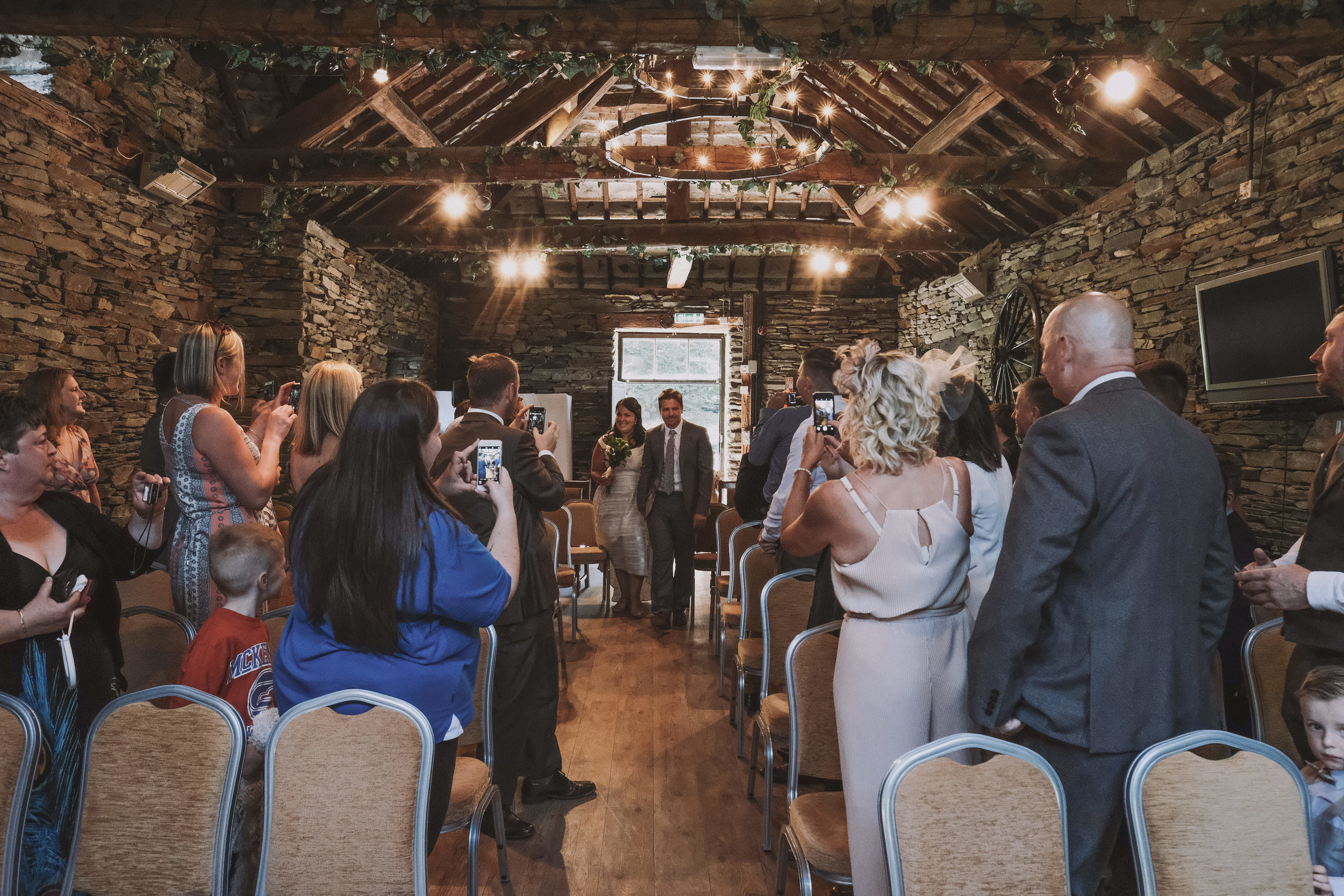 The entrance of the bride and groom at Julia and Darren's Lake District wedding by Barry Forshaw