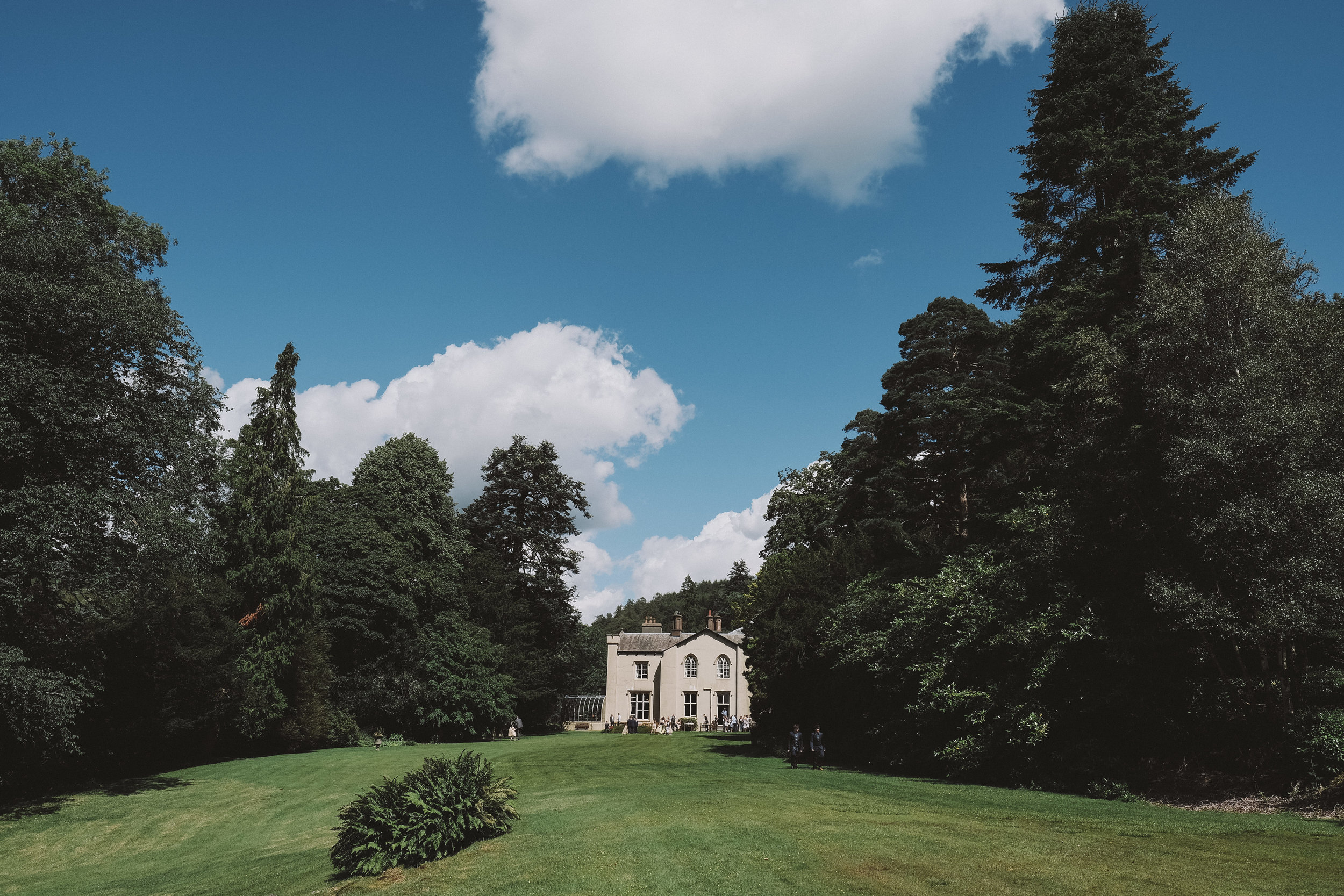 Monk Coniston Hall nestled amongst the trees at Julia and Darren's Lake District wedding by Barry Forshaw
