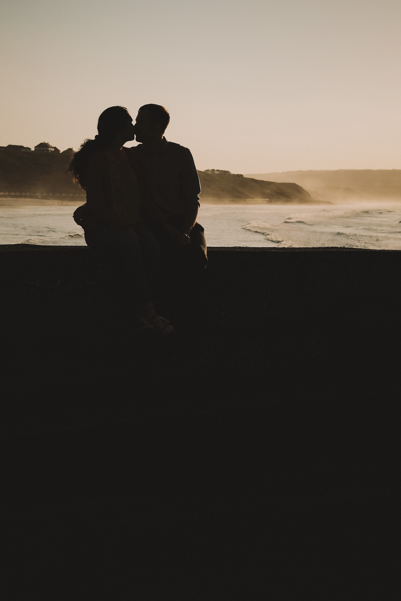 Silhouette of couple kissing at Whitby
