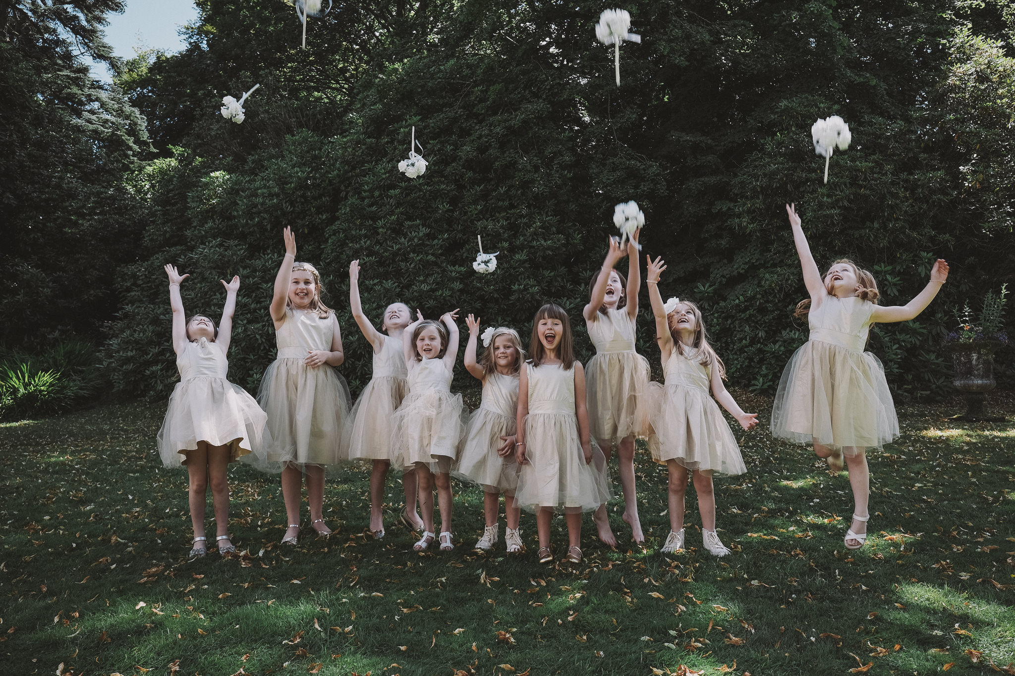 Flowergirls throw their bouquets in the air in the Lake District