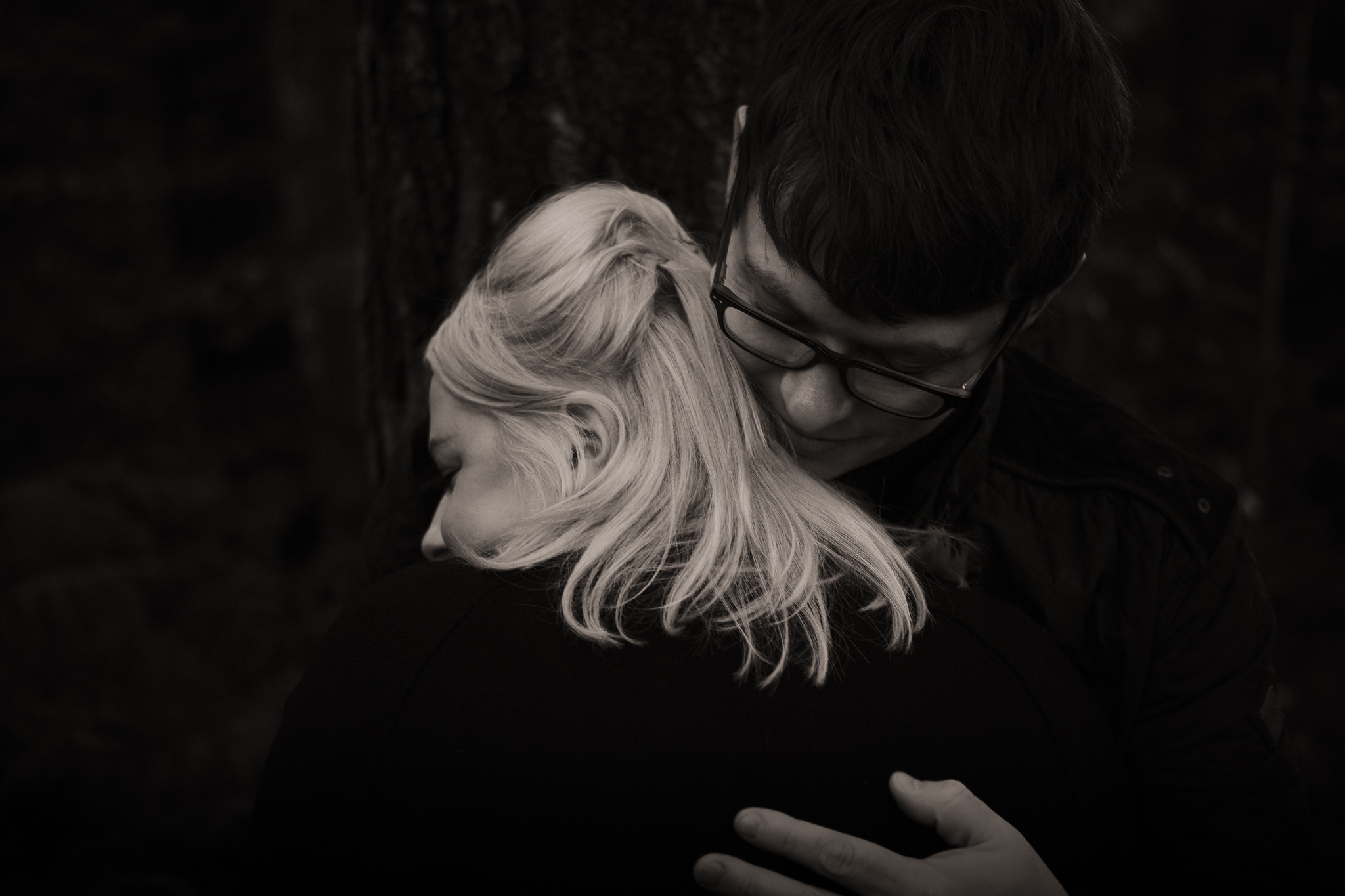 Black and white close up of couple holding each other tight on pre-wedding shoot in Gateshead