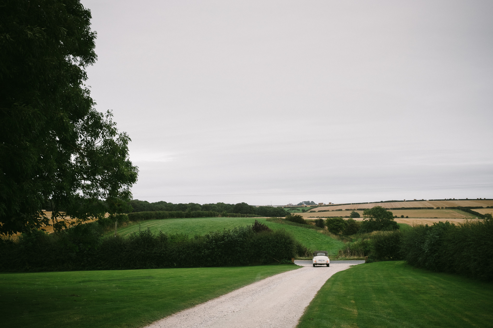 The bride drives to church with rolling Yorkshire countryside in the background
