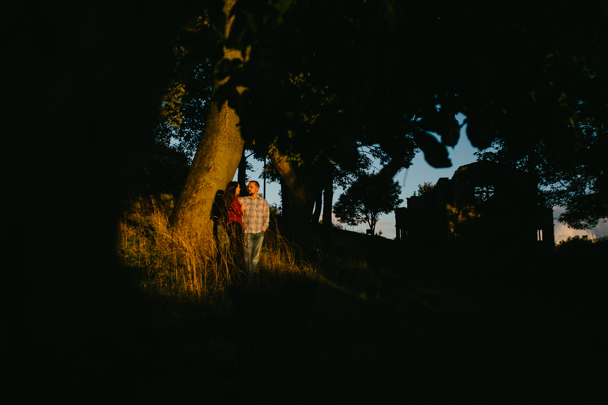 Engaged couple bathed in a pocket of autumn sun in Sunderland