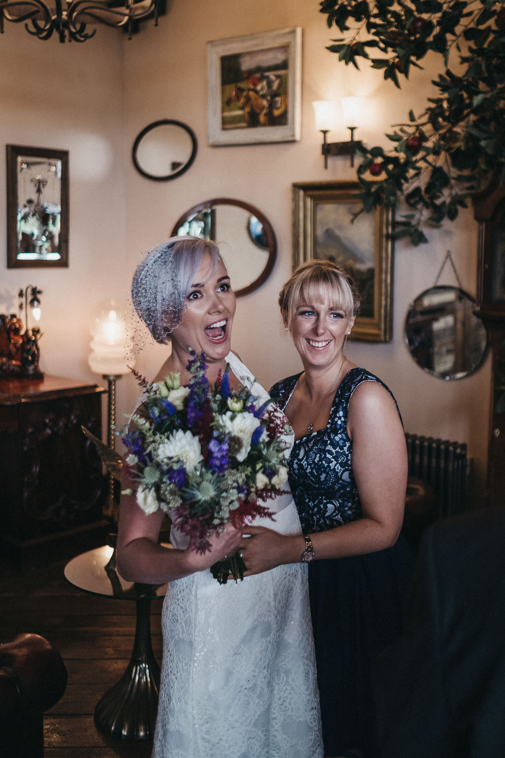 Bride pulls a funny face with guest at wedding