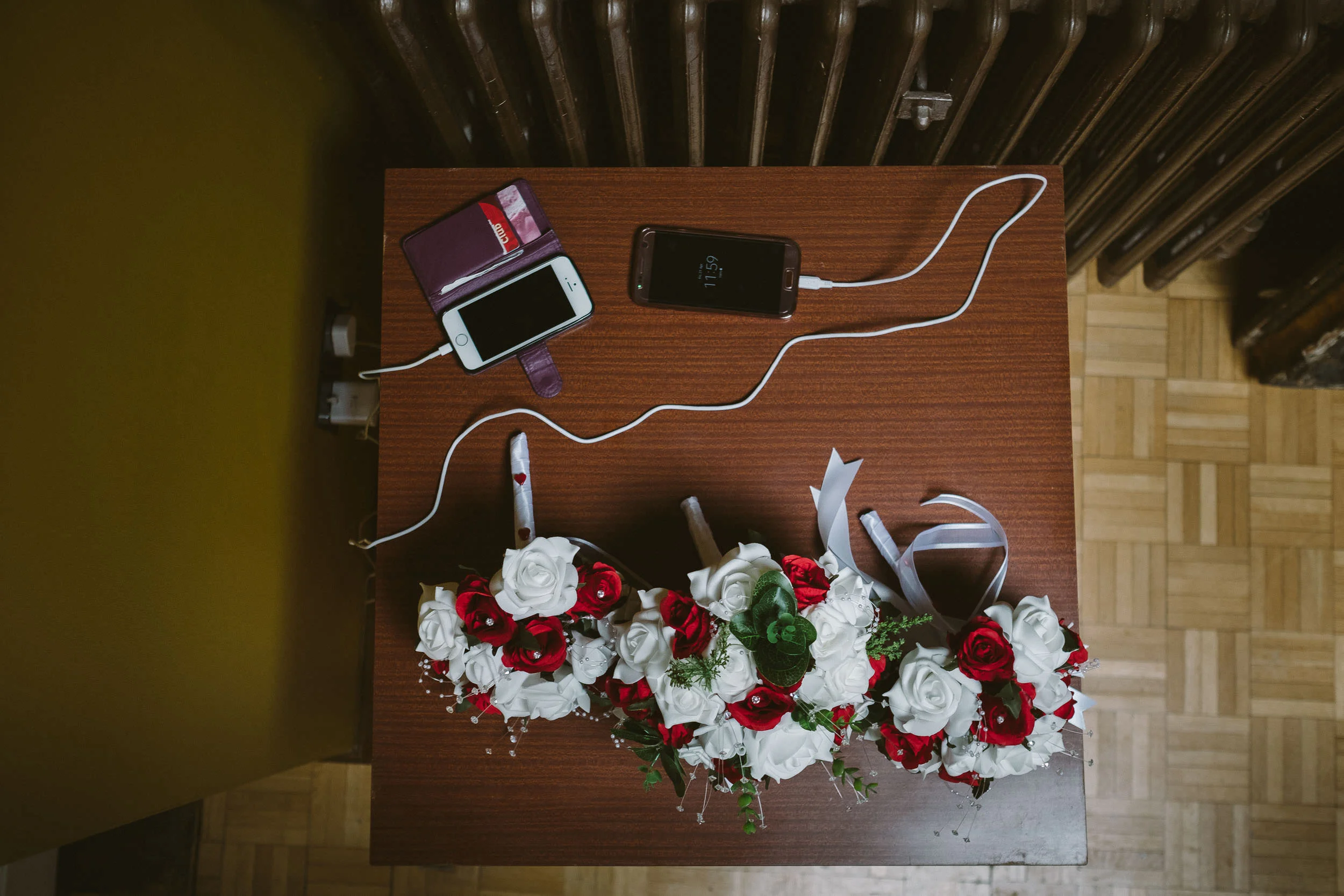 Wedding flowers on table with charging mobile phones