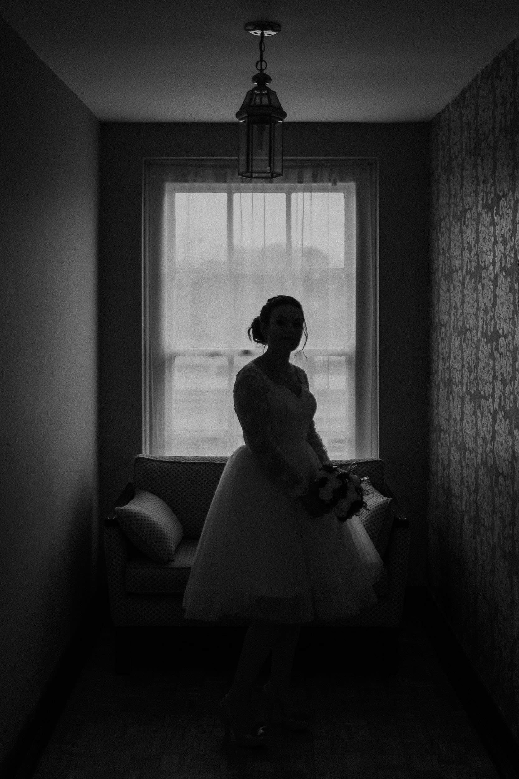 Black and white silhouette photo of bride before ceremony