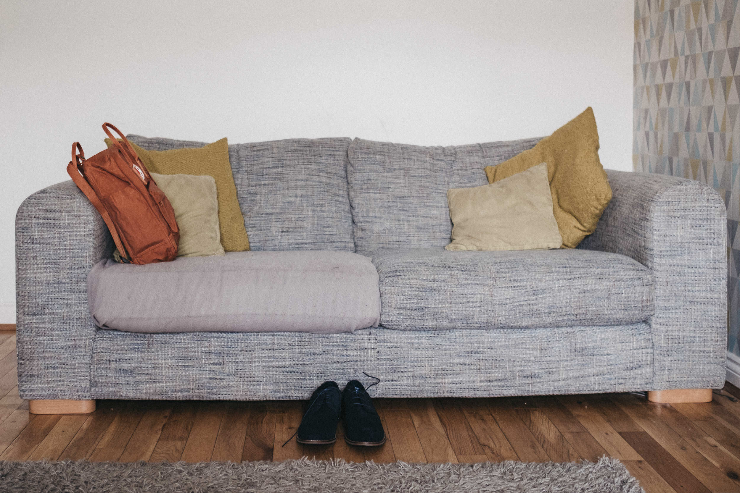 Groom's shoes and bag on sofa