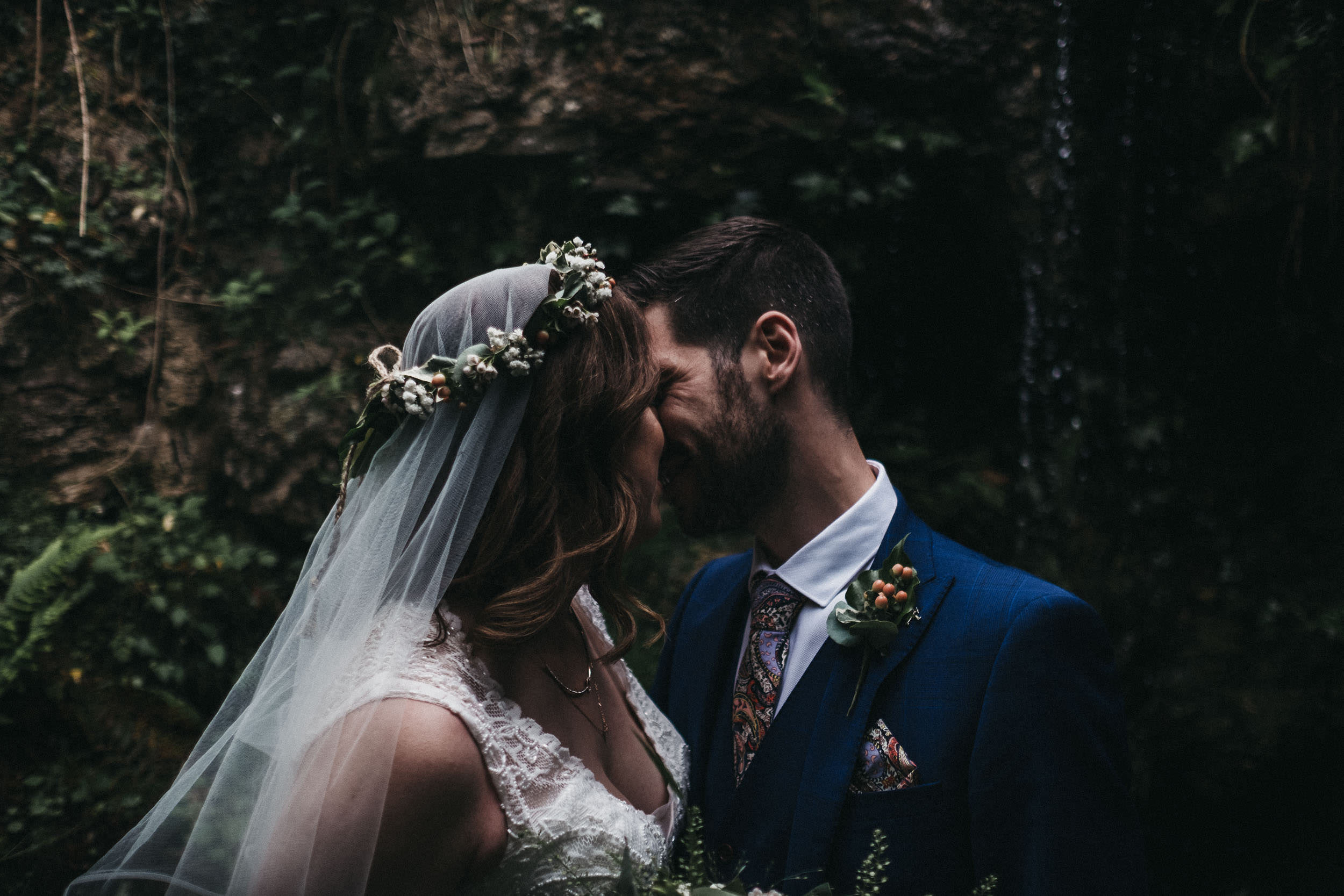 moody photo of bride and groom kissing